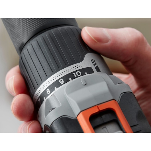 Close-up photo of BLACKDECKER BCD003ME2K cordless drill torque setting ring with numbers and orange trigger.