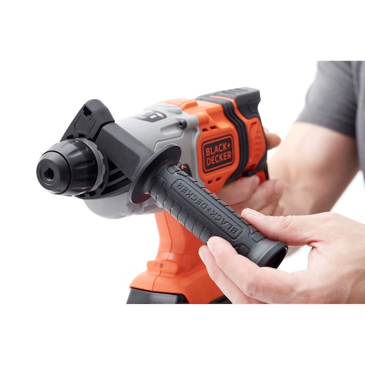 BLACKDECKER BCD900D1S cordless hammer drill front angle, orange and black design, being held by hands.