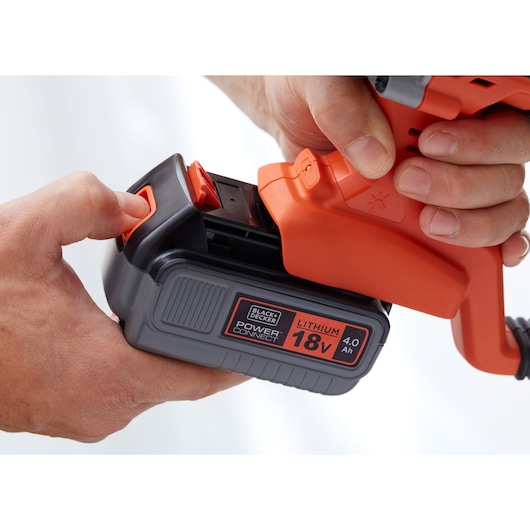 BLACKDECKER 18V lithium 4.0Ah battery being inserted into orange power tool, close-up, BCD900M1K.