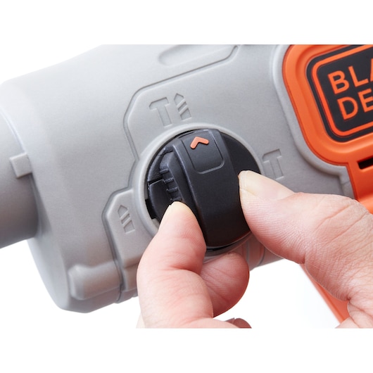 Photo of BLACKDECKER BCD900M1K tool mode selector dial being adjusted, close-up angle.