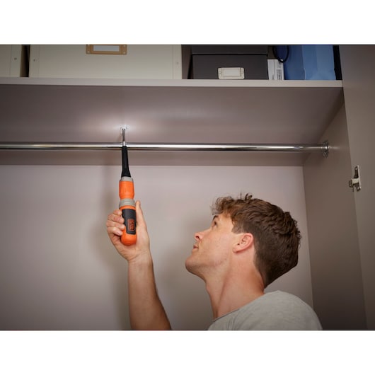 BLACKDECKER BCF602C cordless screwdriver used to secure shelf bracket in closet.
