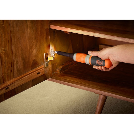 Photo of BLACKDECKER BCF602C cordless screwdriver adjusting cabinet hinge.