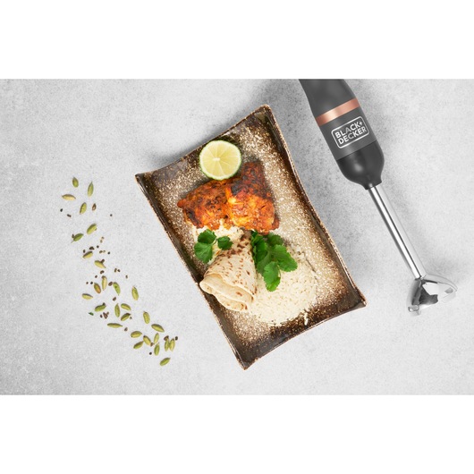 BLACK+DECKER BCKM1011KGF hand blender flat lay with plate of grilled chicken, rice, flatbread, herbs, and lime.
