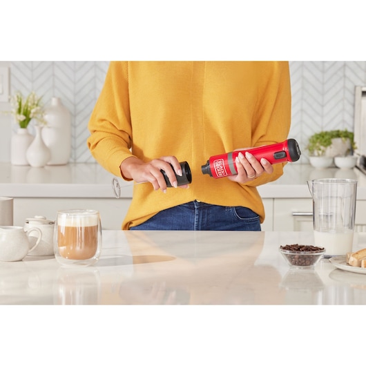 Photo of BLACKDECKER BCKM1012KR red handheld milk frother in a kitchen setting.