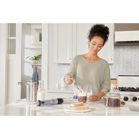 Photo of BLACKDECKER BCKM1016KSG handheld mixer on a kitchen counter near coffee, bread, and a jar of coffee beans.