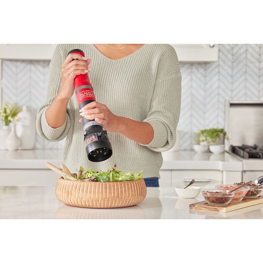 BLACKDECKER BCKM1016KSR electric spice grinder used above salad bowl in kitchen setting.