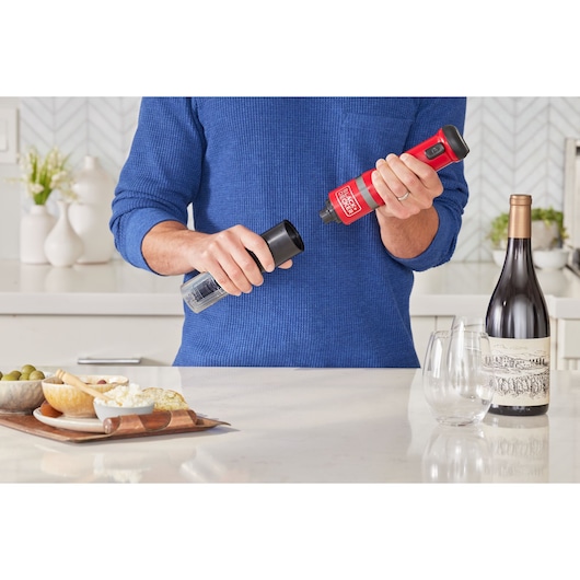 Photo of BLACKDECKER BCKM1016KSR electric salt and pepper grinder held by person in kitchen.