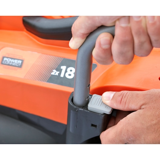 BLACKDECKER BCMW33184L2 lawn mower handle adjustment close-up, orange and black details.