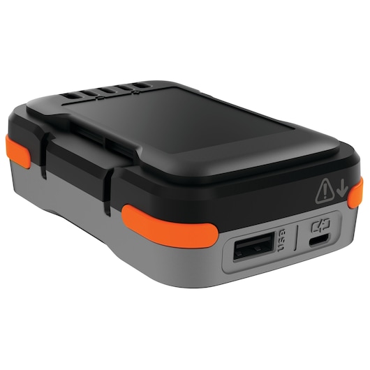 A close-up view of a BLACK+DECKER BDB12 photography accessory featuring a rectangular, rugged design with black and grey housing, orange accents, and visible USB and micro USB ports.