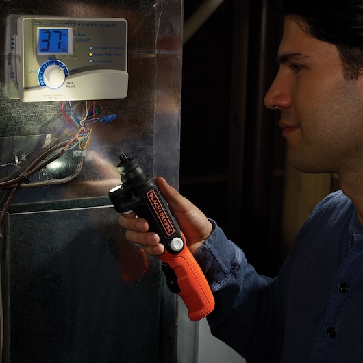 BLACKDECKER BDCSFL20A98 cordless screwdriver with orange handle used near humidifier wiring.