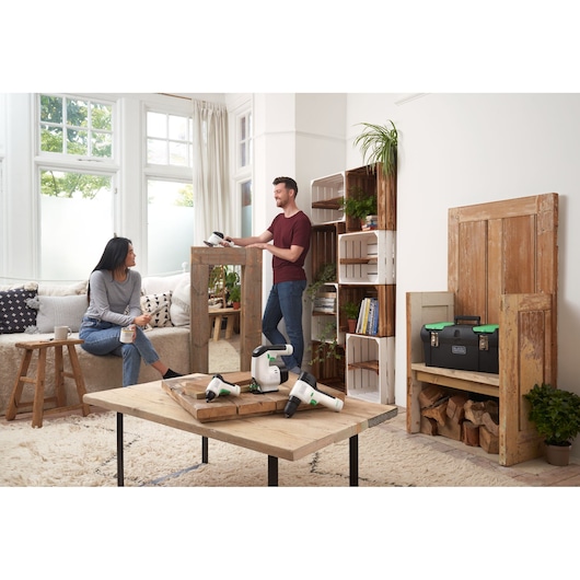 BLACKDECKER BDST60120 tool kit and power tools displayed in living room setting with wood furniture.