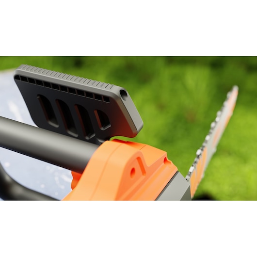 Close-up photo of BLACK+DECKER BECS1835 chainsaw front handle and guide bar, orange and black tool outdoors.