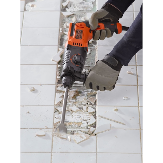 BLACKDECKER BEHS01K rotary hammer chisel removing white tile, photographed from above.