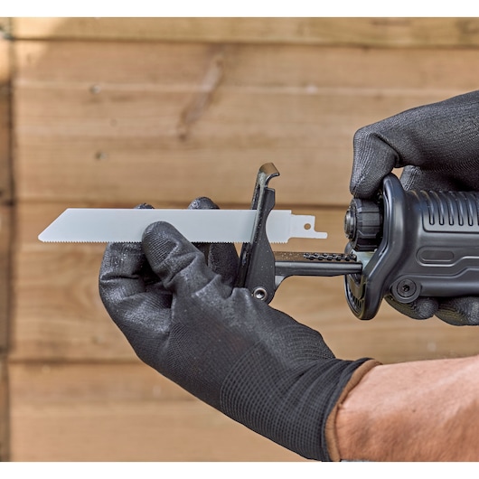 BLACKDECKER BES301K reciprocating saw blade being installed by gloved hands, close-up, product photography.