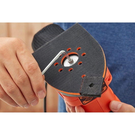 BLACKDECKER BEW200K sander close-up, pad being adjusted with hex key, orange and black body.