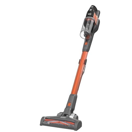 Cordless stick vacuum cleaner with orange and gray design. The vacuum features a transparent dust container and a motorized brush head. Suitable for cleaning floors and carpets.