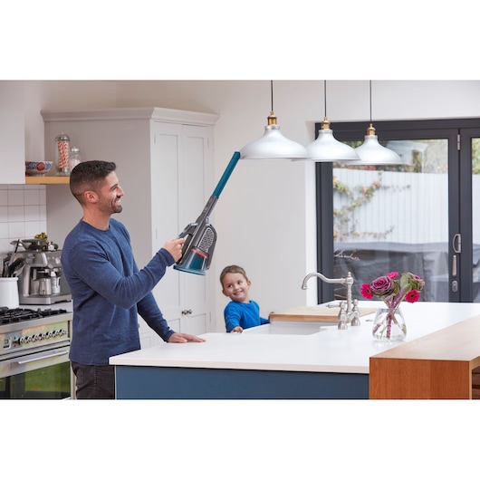 BLACKDECKER BHHV520BF handheld vacuum cleaning high kitchen lamp, modern kitchen setting.