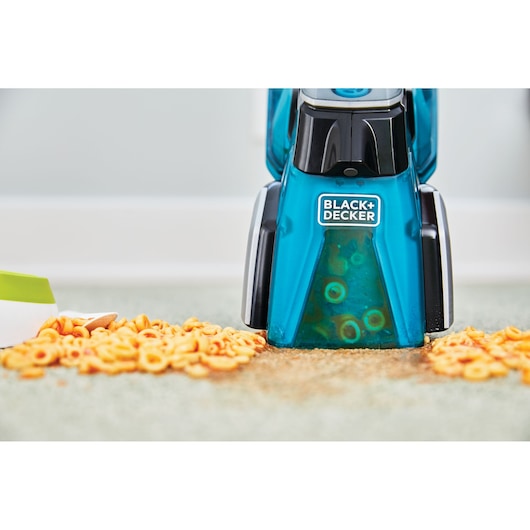 BLACK+DECKER BHSB320JP carpet cleaner front view cleaning spilled pasta from light carpet.