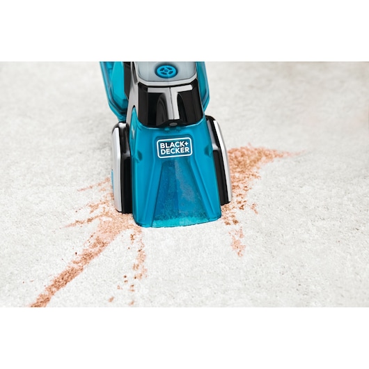 BLACK+DECKER BHSB320JP carpet cleaner nozzle removing stain from light-colored carpet, photography close-up.
