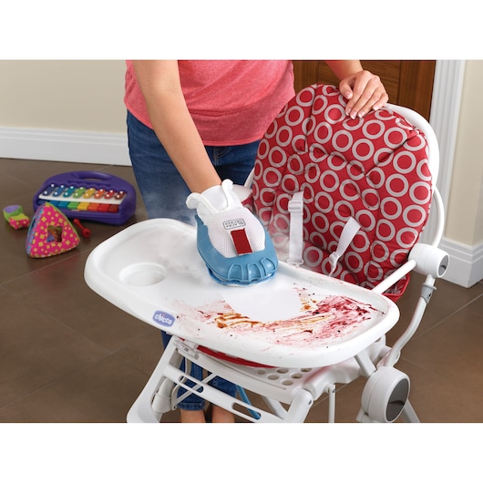 BLACKDECKER BHSM1615DAM steam cleaner cleaning a stained high chair tray, toy keyboard visible in background.