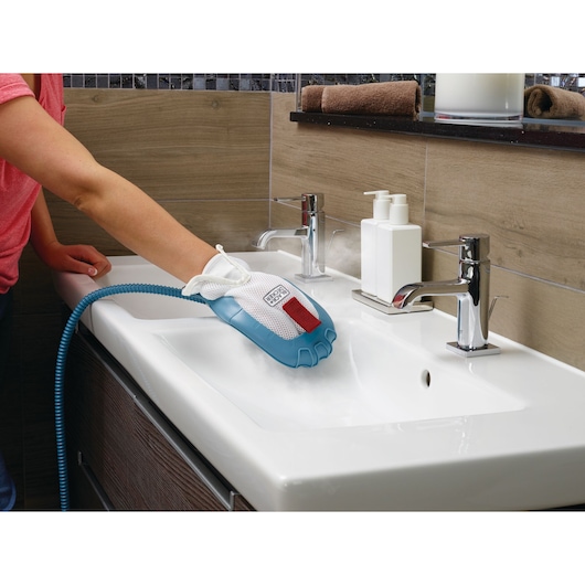 BLACKDECKER BHSM1615DAM steam cleaning glove used on bathroom sink for deep cleaning.