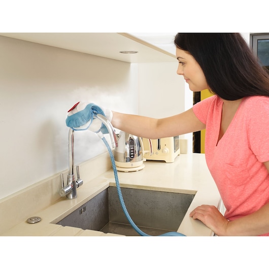 BLACKDECKER BHSM1615DSG steam cleaner used on kitchen faucet, countertop and appliances visible.