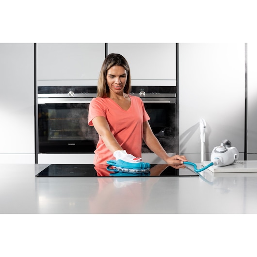 BLACKDECKER BHSM1615DSG steam cleaner with blue and white cleaning attachment used on kitchen countertop, photography.