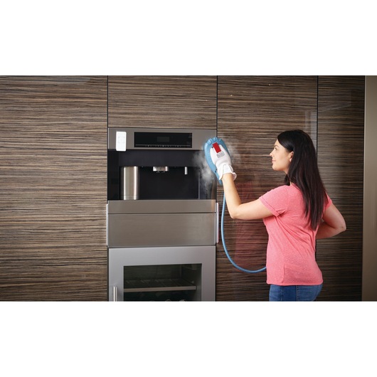 Photo of BLACKDECKER BHSM168DSM steam cleaning glove used to clean a built-in kitchen appliance.
