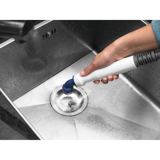 Photo of BLACK+DECKER BHSM168U handheld cleaning brush scrubbing a stainless steel sink.