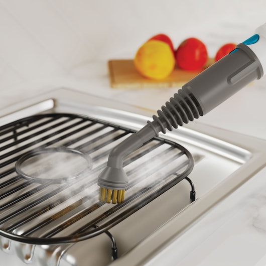 BLACKDECKER BHSMP2314 handheld steam cleaner brush attachment cleaning stovetop grate with steam.