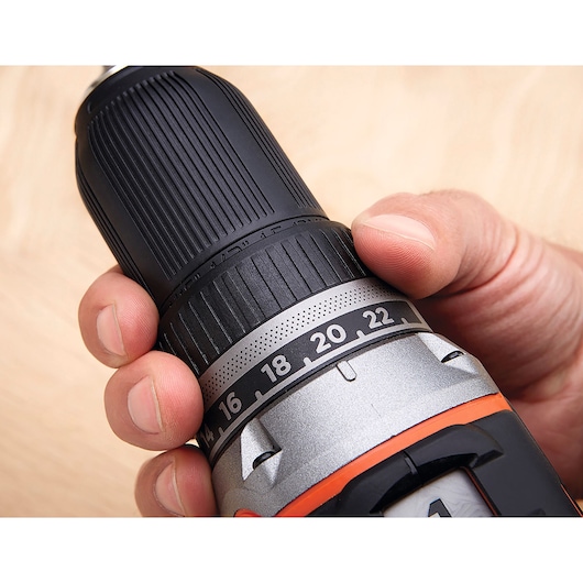 BLACK+DECKER BL186K1B2 cordless drill close-up showing adjustable torque settings, hand holding the grip.