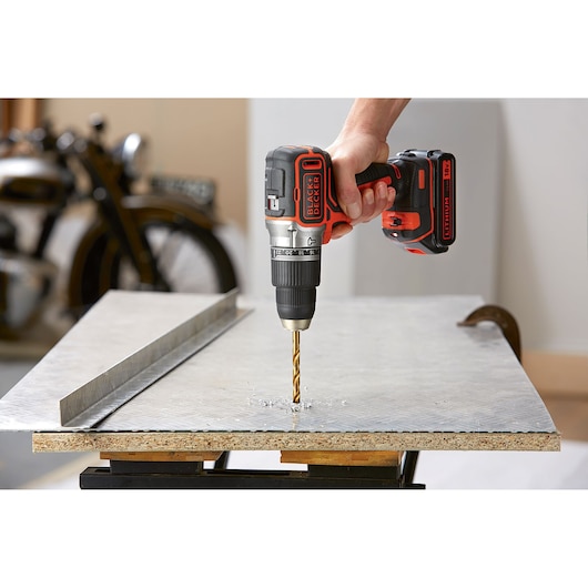 Photo of BLACK+DECKER BL188E2K cordless drill being used to drill a hole in a metal sheet.