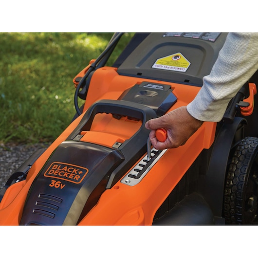 Photo of BLACK+DECKER 36V lawn mower CLMA4820L2 with a hand adjusting height lever.