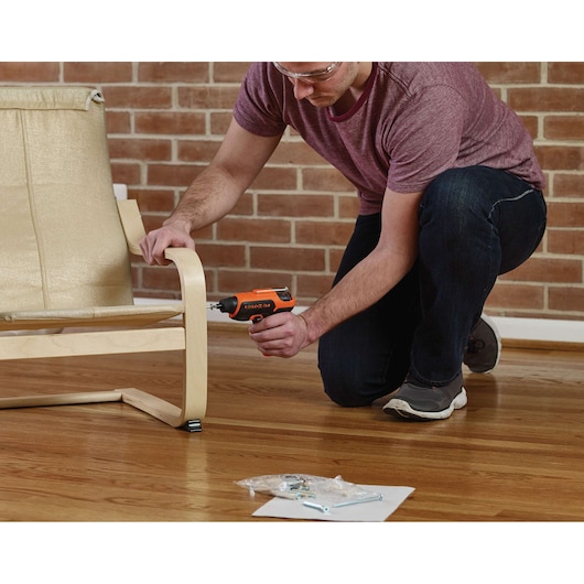 Photo of BLACKDECKER CS36BST cordless screwdriver used to assemble a light wood chair indoors.