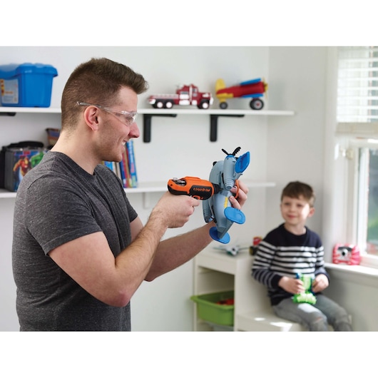 BLACKDECKER CS36BST orange cordless screwdriver used to assemble a toy elephant in a child's room.