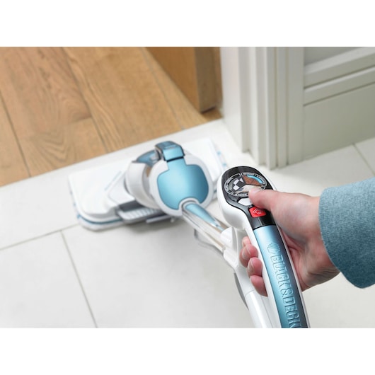 Photo of BLACKDECKER FSM1630 steam mop handle with control dial cleaning a tiled floor near wood.