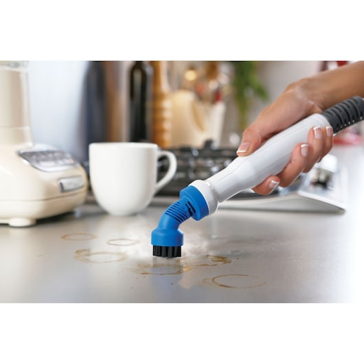 BLACKDECKER FSMH1321JSM steam cleaner with blue brush attachment cleaning kitchen countertop.