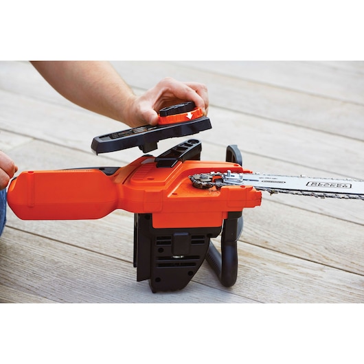 Photo of BLACKDECKER GKC3630L20 cordless chainsaw with cover removed, showing chain area during maintenance.