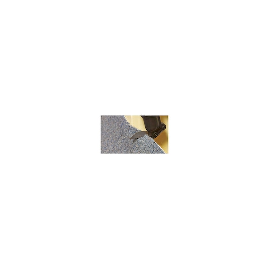 BLACKDECKER MTS12 oscillating tool blade cutting gray carpet, close-up.