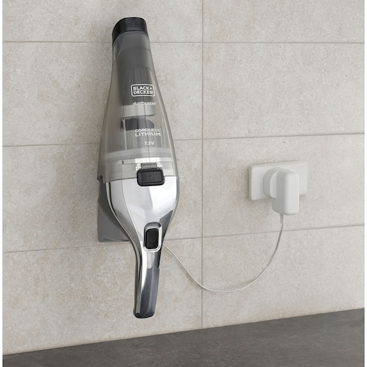 Photo of BLACK+DECKER NVC220WC cordless handheld vacuum on wall charger, side view.