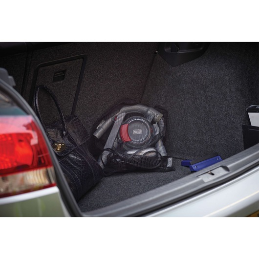 BLACKDECKER PD1200AV portable car vacuum in gray and red stored in vehicle trunk with accessories.